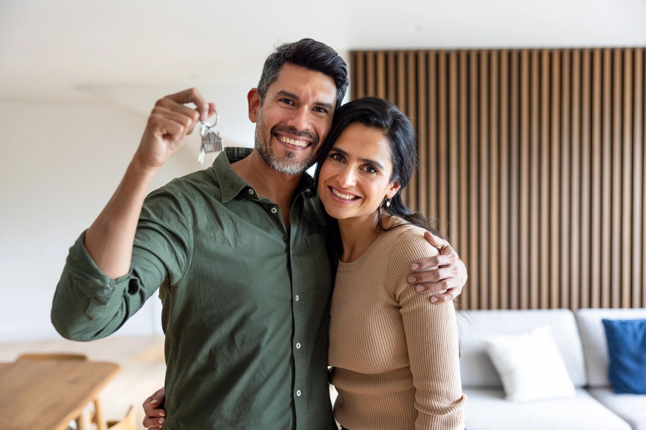 Happy couple holding the key to their new home